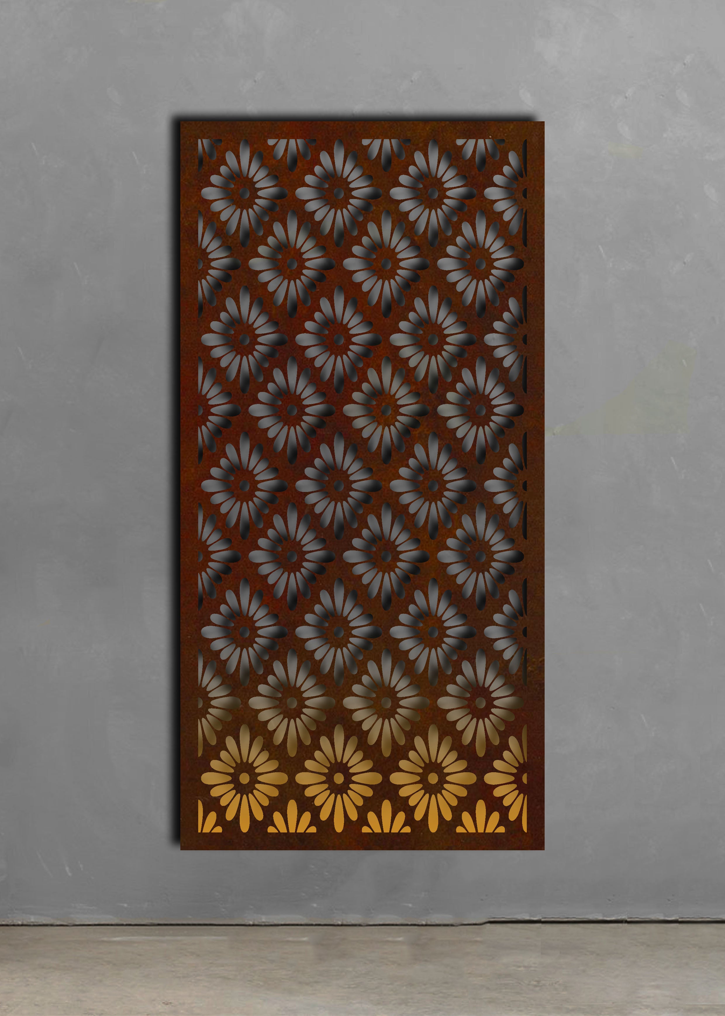 African Daisy Screen on a concrete wall with a rust patina.  Brief Description: This image features an African Daisy Screen displayed against a concrete wall with a rust patina finish. The screen’s elegant floral design adds a touch of sophistication to the space. The rust patina on the concrete wall complements the screen, highlighting its detailed laser-cut patterns.